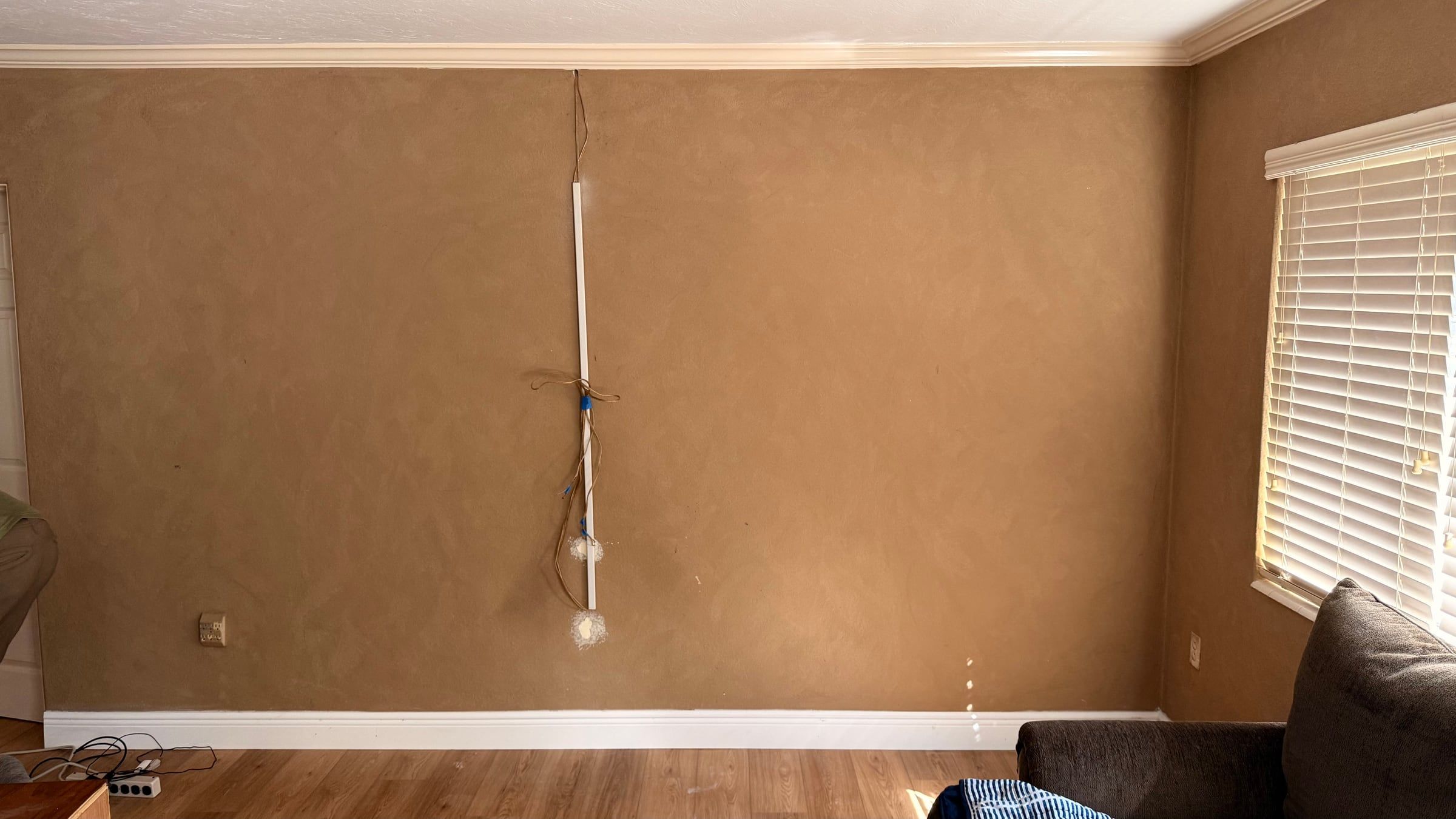 Black Media Wall with Electric Fireplace and Lit Floating Shelves in Sarasota, FL — before
