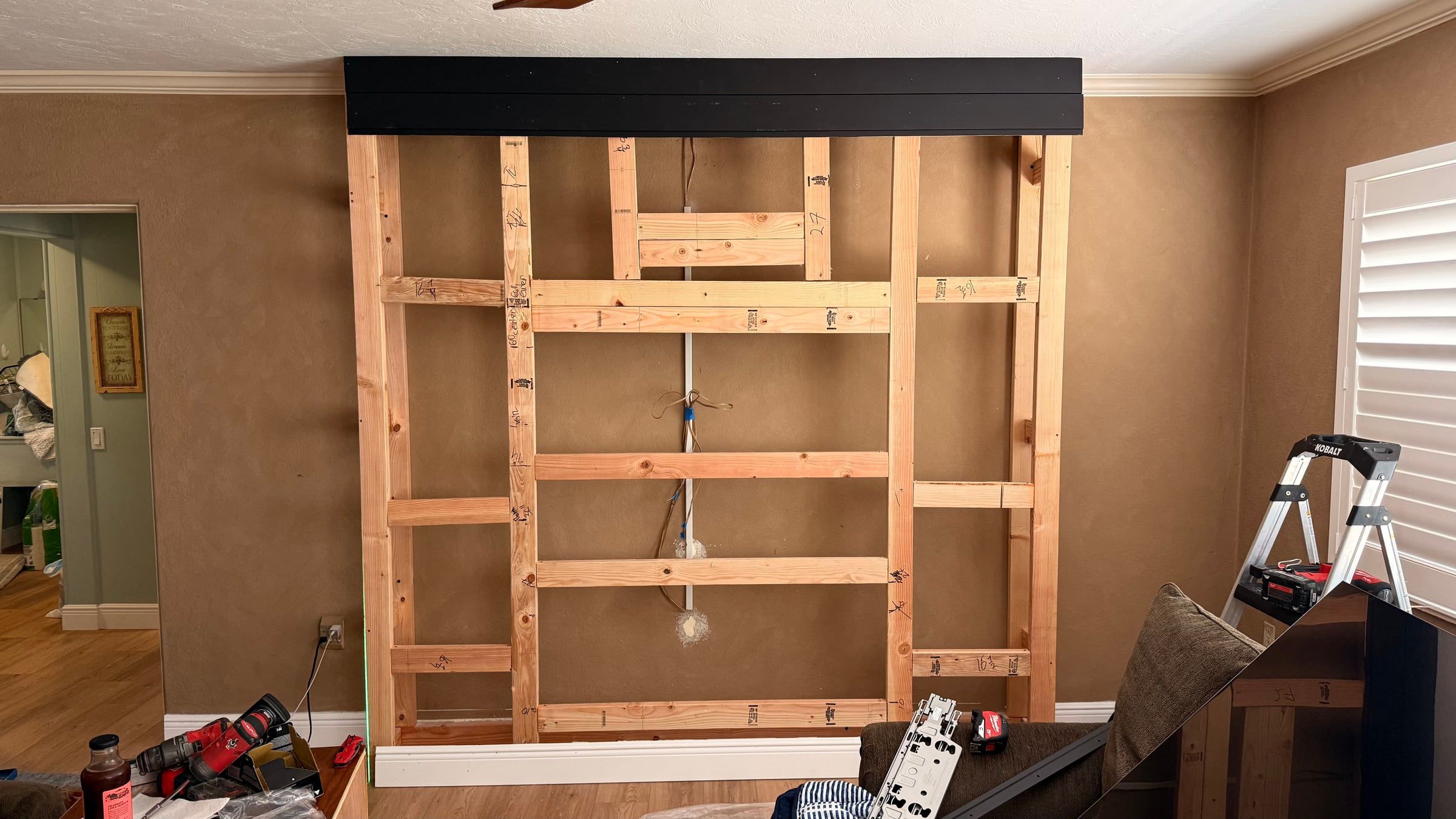 Black Media Wall with Electric Fireplace and Lit Floating Shelves in Sarasota, FL — photo 2 of 5