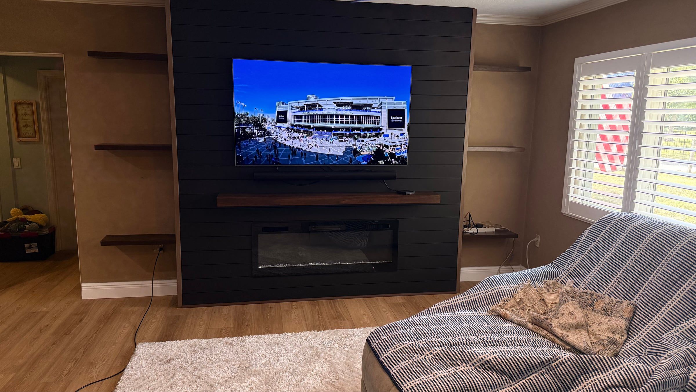 Black Media Wall with Electric Fireplace and Lit Floating Shelves in Sarasota, FL — after