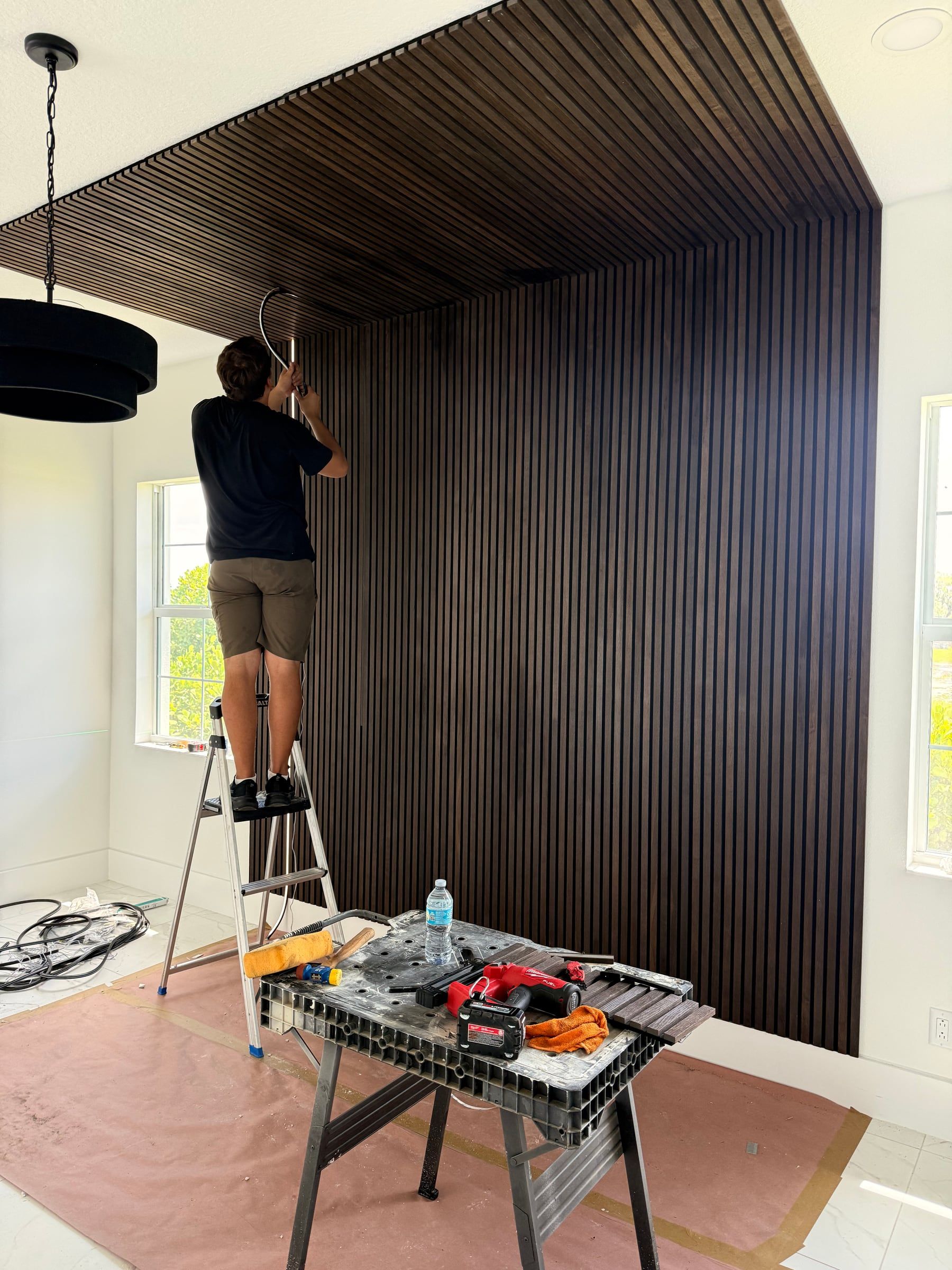 Dark Wood Slat Accent Wall That Wraps onto the Ceiling in Windermere, FL — photo 1 of 3
