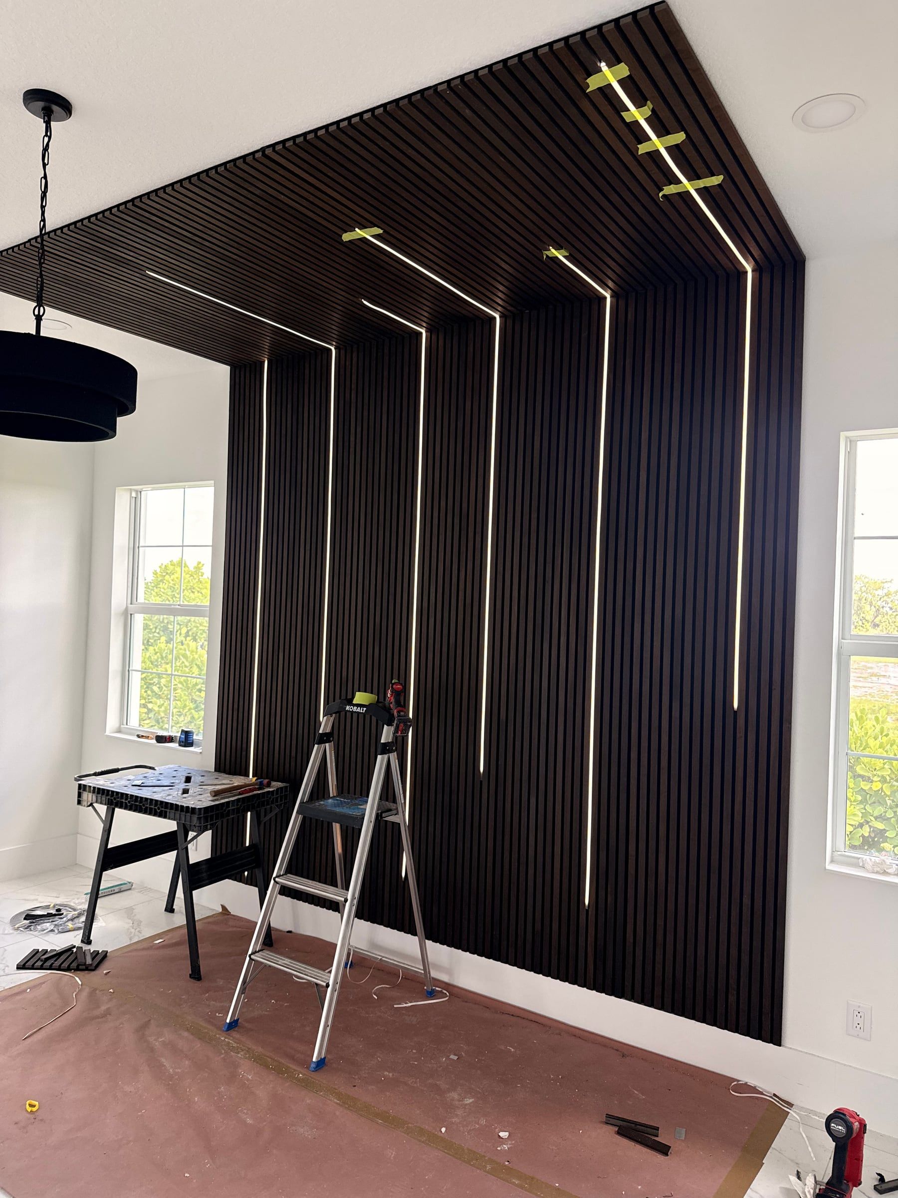 Dark Wood Slat Accent Wall That Wraps onto the Ceiling in Windermere, FL