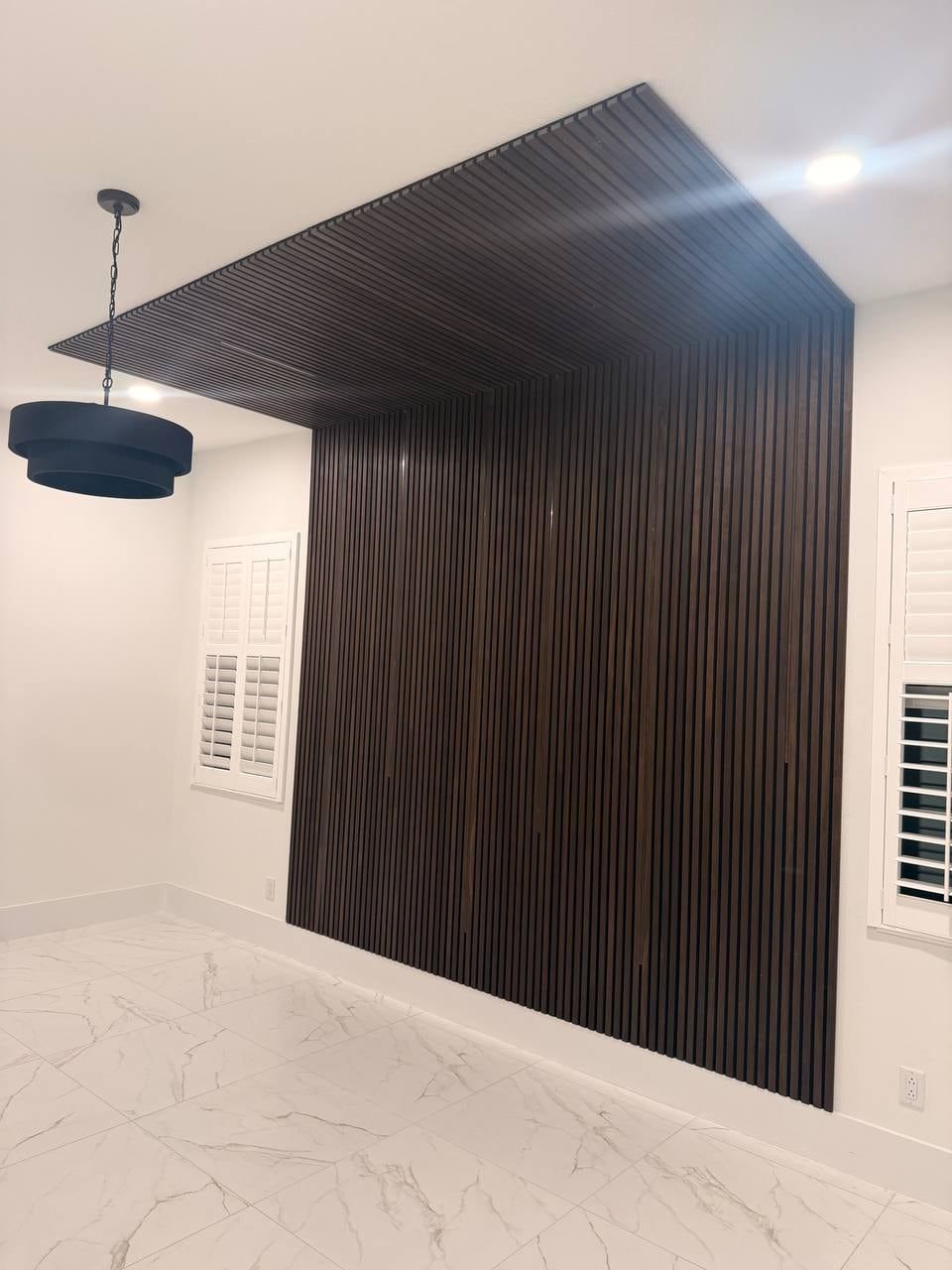 Dark Wood Slat Accent Wall That Wraps onto the Ceiling in Windermere, FL — photo 3 of 3